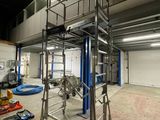 a picture of a large industrial building with a ladder in the middle of it