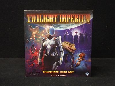 the twilight imperium board game is sitting on a black surface