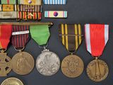 a lot of medals and medals on a black surface