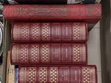many books stacked on top of each other in a box