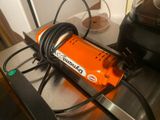 an orange machine that is sitting on top of a counter