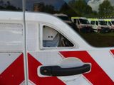 a white van with a red and white stripe on the side
