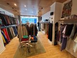 an image of a clothing store with a lot of clothes
