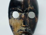 an image of a wooden mask on a stand