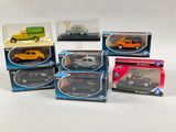 six different models of cars in boxes on a white surface