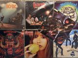 several albums of heavy rock music are on display on a table