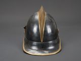 a silver helmet with gold trims on a gray background