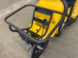 a yellow scooter that is parked in a garage