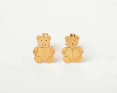 a pair of teddy bear stud earrings on a white background