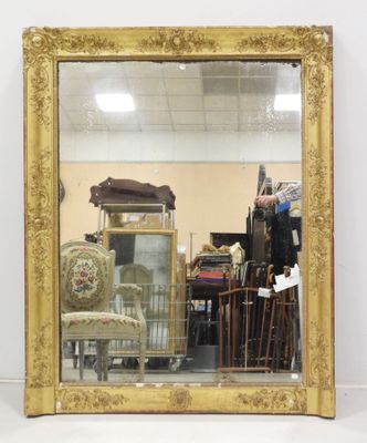 a mirror that is sitting on the floor in front of a chair