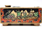a small wooden box with a painting on it