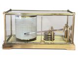a glass display case with a barometer inside of it