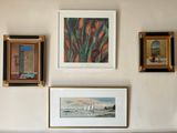 many pictures on the wall above a couch