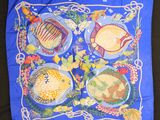 an image of a blue scarf with fish and flowers on it