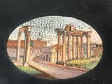 a picture of a black box with a picture of a roman city
