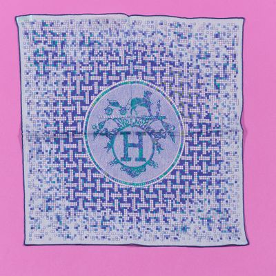 a blue and white square with a cross stitch design on it
