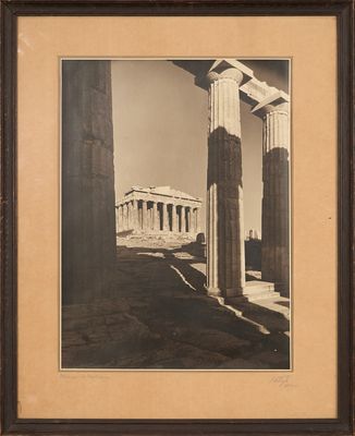 an old photo of an ancient building with columns and a sky background