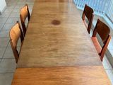 a long wooden table with six chairs around it