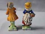 two figurines of two people standing next to each other