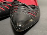 a close up of a pair of black shoes on a table