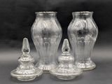 three clear glass vases sitting next to each other on a table