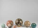 several different colored marbles sitting on top of a white surface