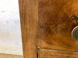 a wooden cabinet with two drawers on top of it