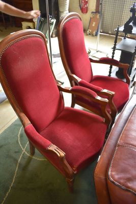 two red chairs sitting next to each other in a room