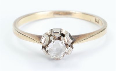 a close up of a diamond ring on a white surface