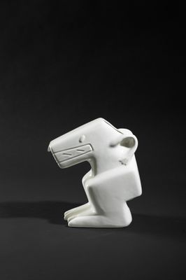 two white ceramic sculptures of a man and a woman on a black background