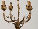 a large metal candelier with five candles on it