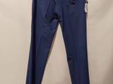 a pair of blue pants hanging on a hanger on a wall