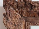 a close up of a wooden frame with carvings on it