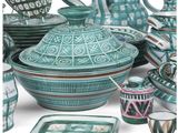 a large collection of green and white dishes and cups