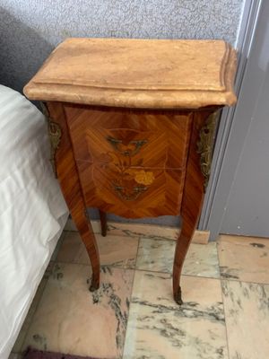 a small wooden table with a drawer on top of it