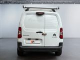 the back of a white van is parked in a garage