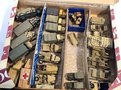 une boîte remplie de véhicules militaires miniatures et d'autres objets