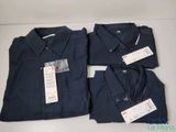 three pairs of men ' s navy blue shirts with tags on them