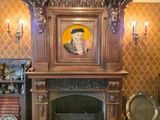 a picture of a fireplace in a room with a picture on the mantle