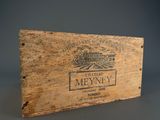 an old wooden box with a label on it sitting on a table