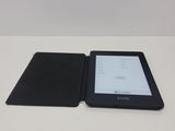 a kindle on the table next to the kindle