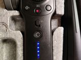 a remote control sitting on top of a table next to a cell phone