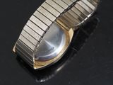 a close up of a watch on a black surface