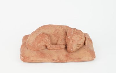 figurine of a sleeping dog on a rock