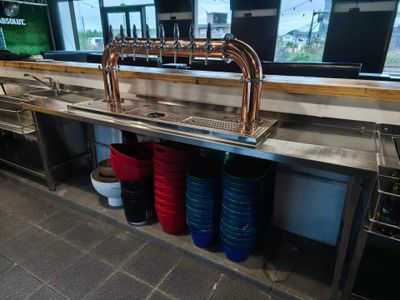 a sink with a faucet and a bunch of buckets