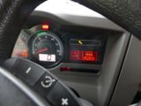 a close up of a car dashboard with a clock on it