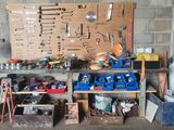 a workbench with many tools on it in a garage