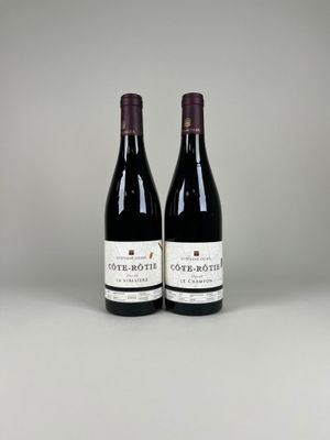 two bottles of wine sitting on top of a table