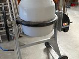 une bétonnière posée sur un chariot dans un entrepôt