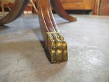 a wooden table that has a gold handle on it